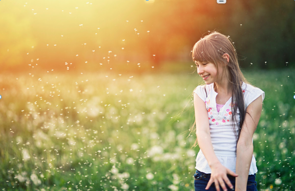 Relieve Seasonal Allergies Naturally. Image Girl standing in field. Pollen in the air. 